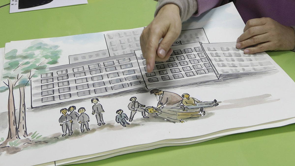In this Dec. 21, 2018, photo, North Korean defector Kwak Jeong-ae, 65, shows a drawing about North Korea during an interview in Uijeongbu, South Korea. Experts and defectors say most of North Korea’s underground Christians do not engage in the extremely dangerous work of proselytizing. Instead, they largely keep their beliefs to themselves or within their immediate families.