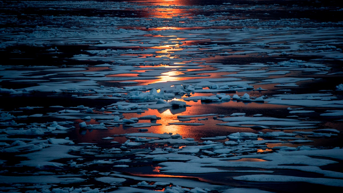 FILE- In this July 23, 2017, file photo the midnight sun shines across sea ice along the Northwest Passage in the Canadian Arctic Archipelago.