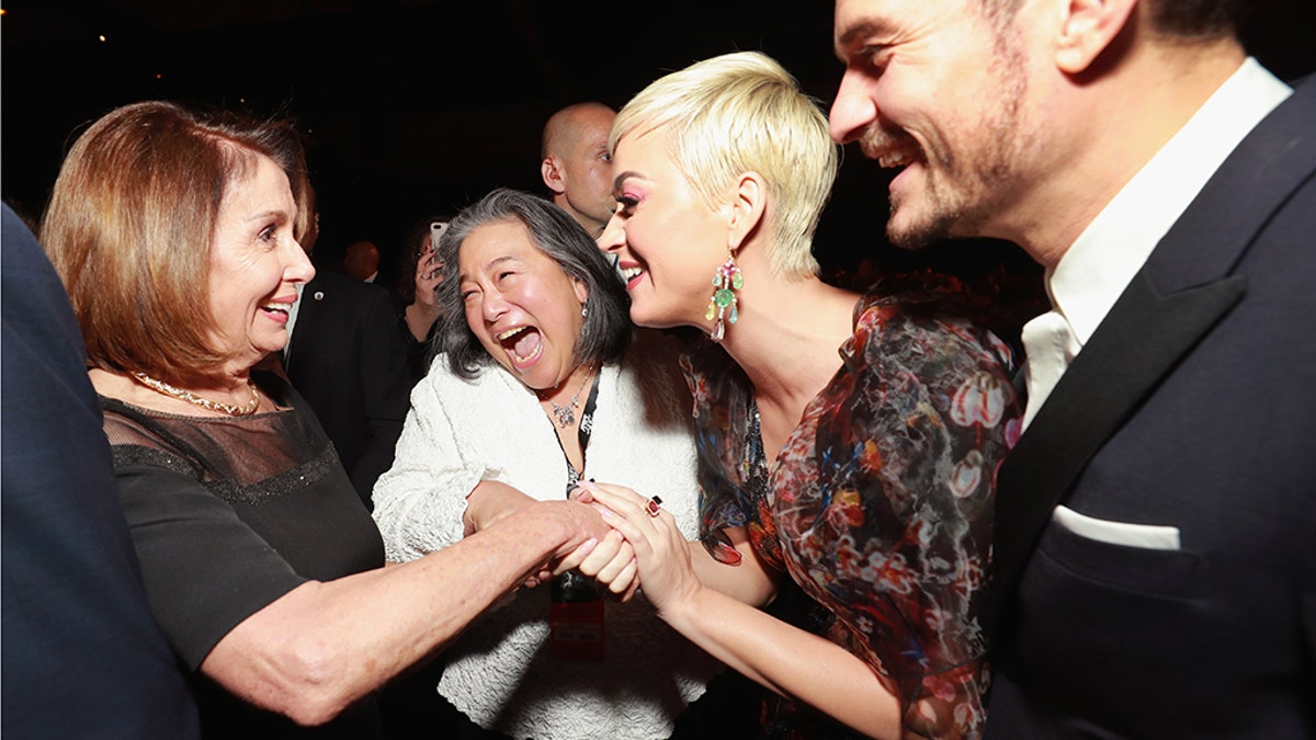 Nancy Pelosi (L), Katy Perry (2nd R) and Orlando Bloom (R) attend MusiCares Person of the Year honoring Dolly Parton at Los Angeles Convention Center on February 8, 2019 in Los Angeles, California. 