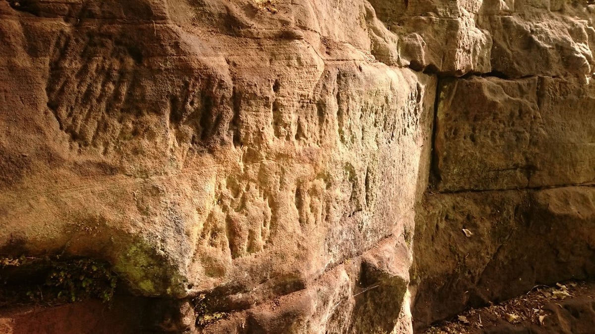 Roman graffiti carved into the soft sandstone of the quarry in Gelt Forest. (Historic England)