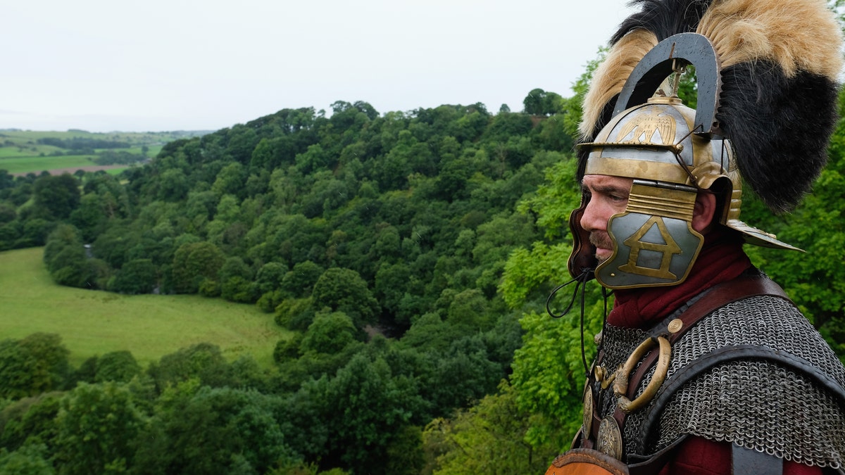 File photo - A reenactor dressed as a Roman soldier stands guard looking out over the countryside of Cumbria from the Birdoswald Roman Fort as the lives of Roman Legionnaires are re-enacted during the Hadrian's Wall Live event on Sept. 3, 2016 in Carlisle, England. (Photo by Ian Forsyth/Getty Images)