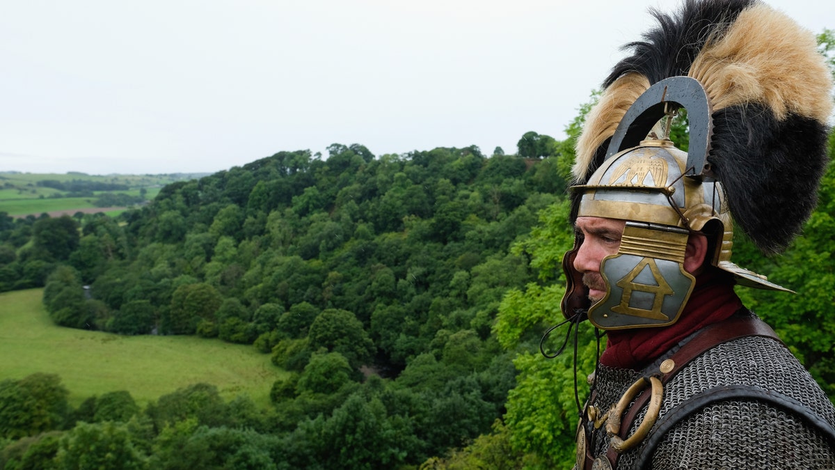 File photo - A reenactor dressed as a Roman soldier stands guard looking out over the countryside of Cumbria from the Birdoswald Roman Fort as the lives of Roman Legionnaires are re-enacted during the Hadrian's Wall Live event on Sept. 3, 2016 in Carlisle, England. (Photo by Ian Forsyth/Getty Images)