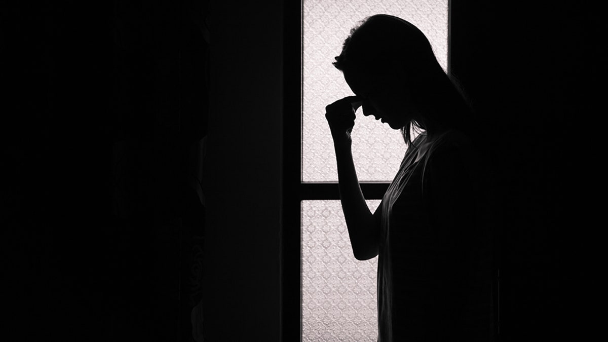 Woman standing alone in room