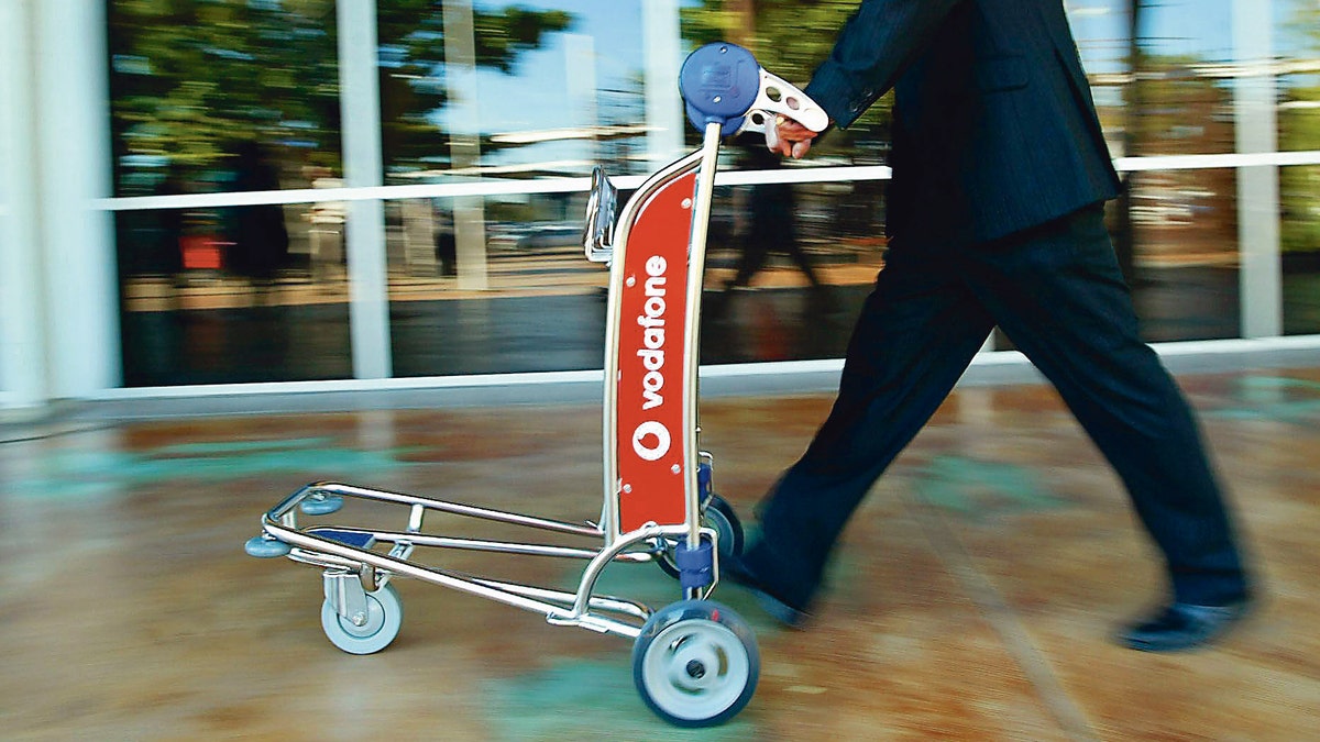 The woman was seen trying to push the luggage cart while it was upturned on its side.