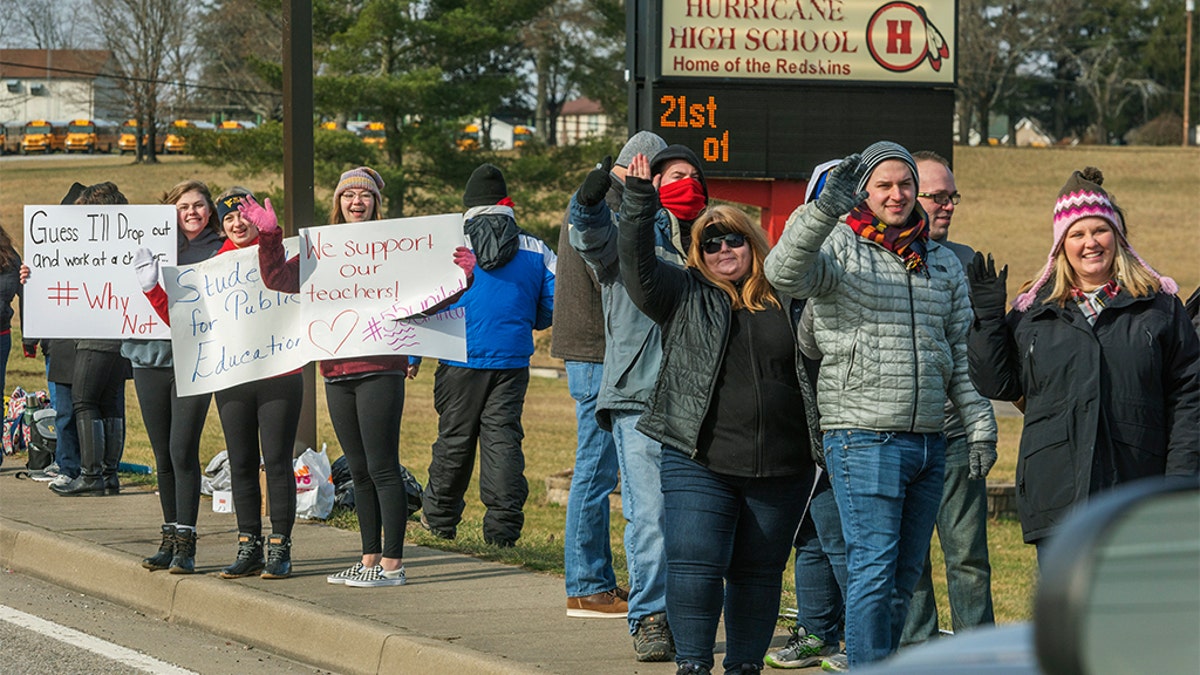 Teachers, students and supporters protested outside of Hurricane High School in Putnam County, West Virginia on Tuesday, Feb. 19, 2019. 