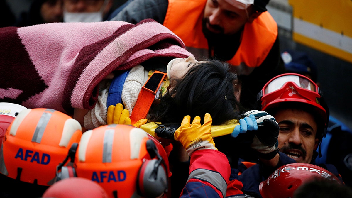 Rescuers carry a girl on a stretcher at the site of a collapsed residential building in the Kartal district, Istanbul, Turkey, February 7, 2019.