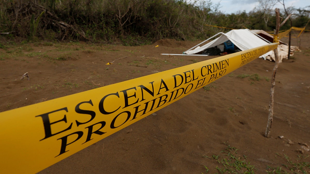 A police cordon marks the perimeter of the site where a forensic team and judicial authorities work in unmarked graves where skulls were found, on the outskirts of Veracruz, Mexico March 16, 2017.