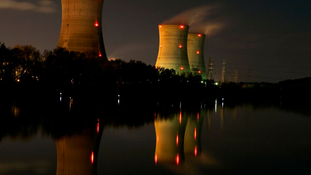 FILE - In this file photo of Nov. 2, 2006, cooling towers of the Three Mile Island nuclear power plant are reflected in the Susquehanna River in this time exposure photograph in Middletown, Pa. Forty years after Three Mile Island became synonymous with America's worst commercial nuclear power accident, the prospect of bailing out nuclear power plants is stirring debate at the highest levels of Pennsylvania and the federal government. (AP Photo/Carolyn Kaster, File)