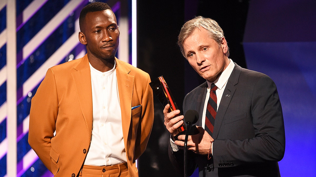 CORRECTS MONTH TO FEBRUARY INSTEAD OF JANUARY - Mahershala Ali, left, presents the Best Actor award to Viggo Mortensen for 