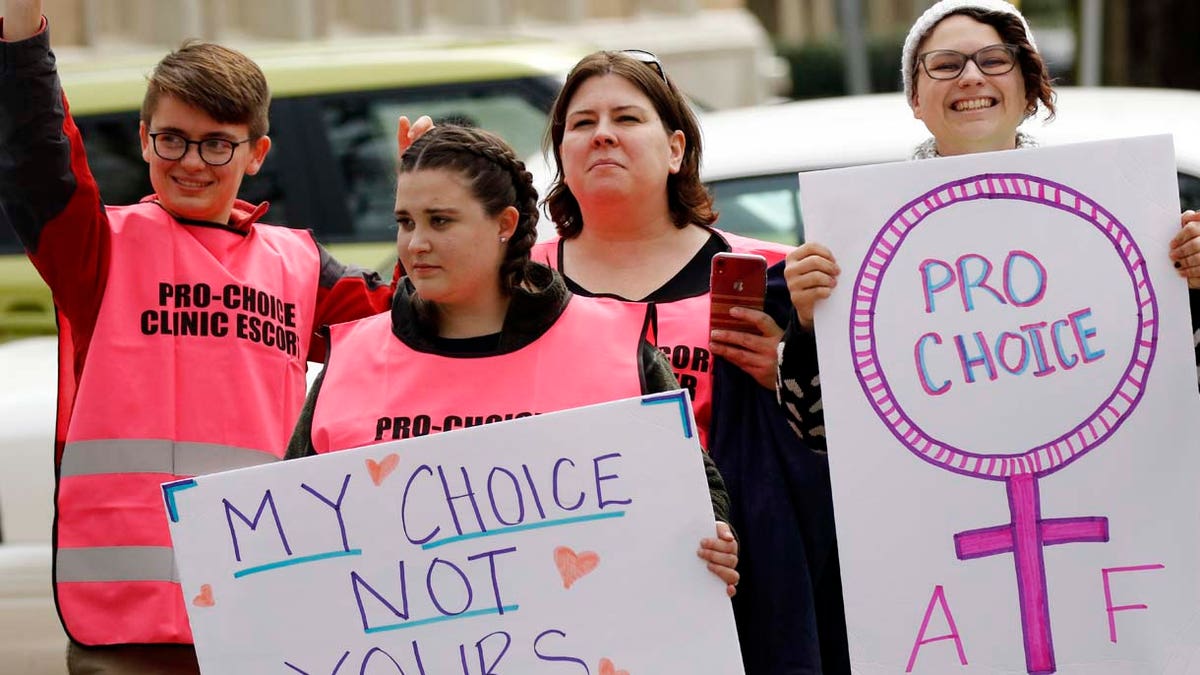 Abortion rights advocates hold signs in support of choice, at the Capitol in Jackson, Miss