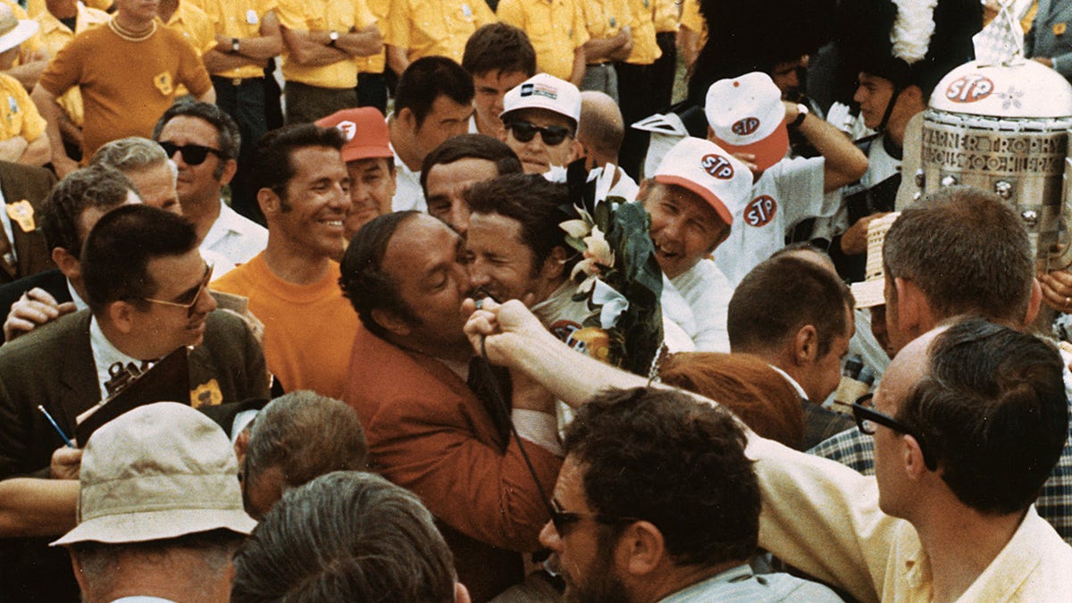 Team owner Andy Granatelli gave Mario Andretti a big kiss after his 1969 Indy 500 victory.