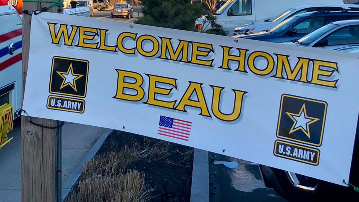 One of the signs greeting Beau Schlichting at his surprise homecoming Saturday in Winthrip, Mass., after a nine-month deployment in Afghanistan with the U.S. Army.