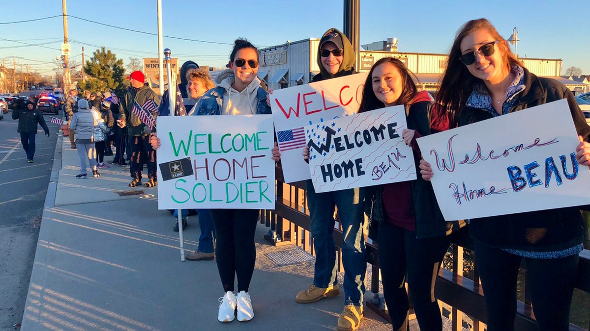 Dozens lined a bridge into Winthrop, Mass., Saturday to surprise U.S. Army soldier Beau Schlichting who returned home from a nine-month deployment in Afghanistan.