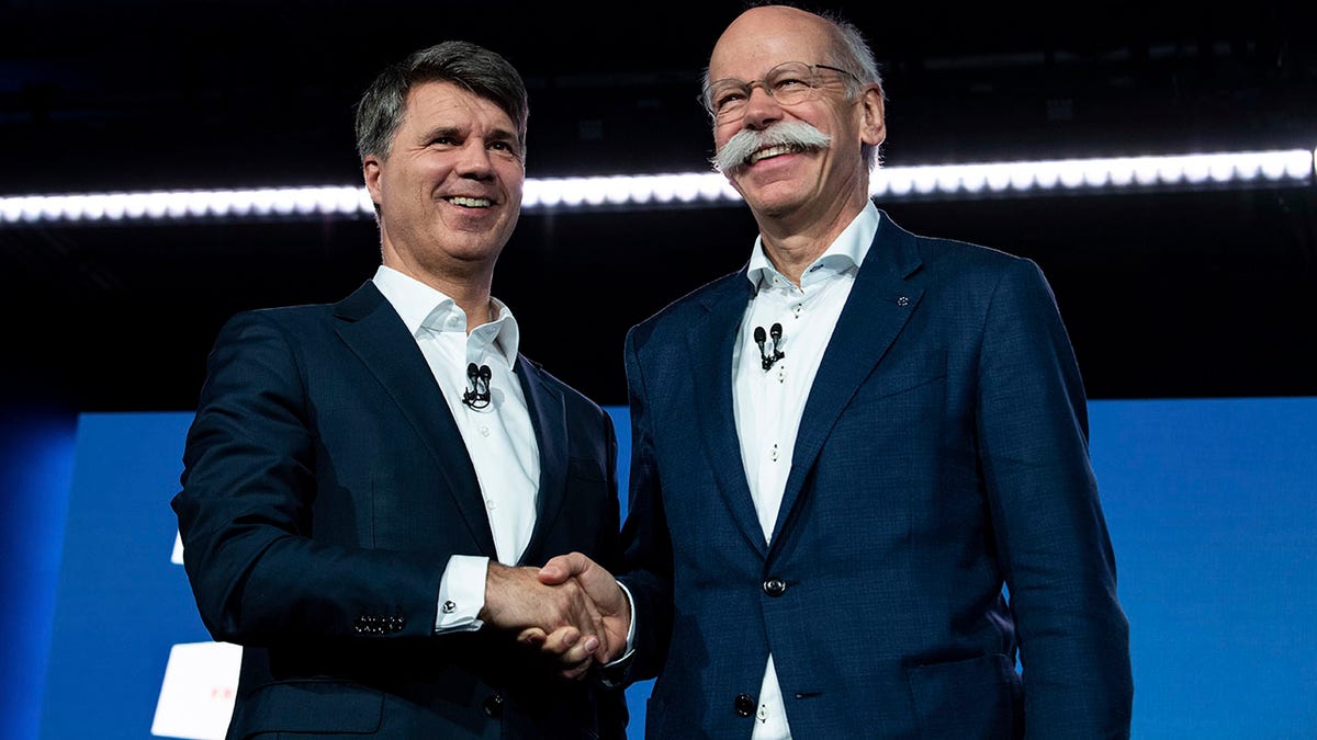 BMW CEO Harald Krueger, left, and Mercedes-Benz CEO Dieter Zetsche of Daimler, right, announced the agreement in Berlin.