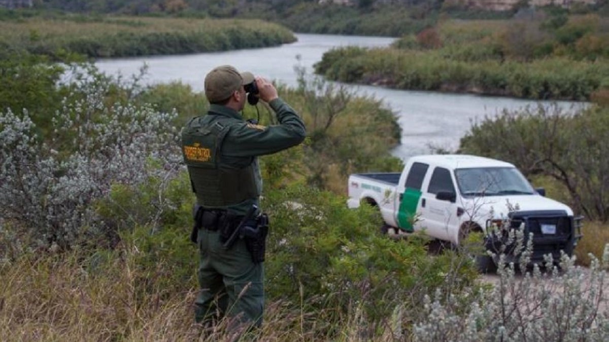 A Border Patrol agent overlooks Mexico from Eagle Pass, Texas. A Honduran woman detained while trying to cross into the U.S. illegally claims she was kidnapped and held for ransom by human smugglers in Mexico.