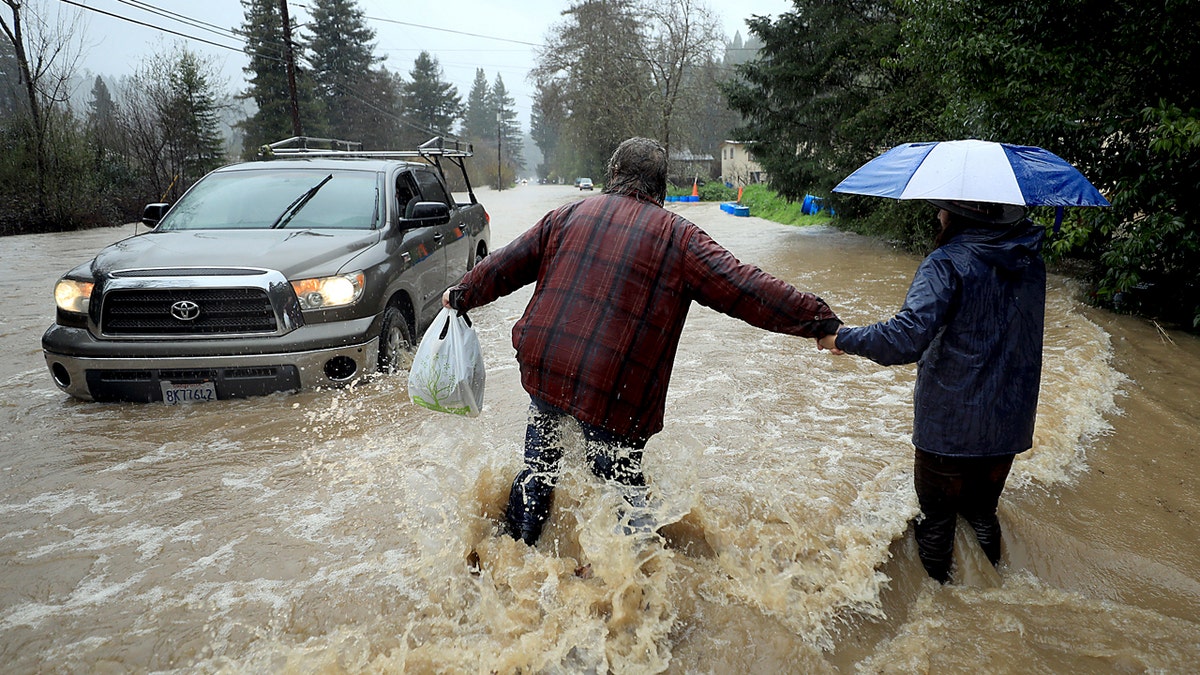 Residents along Armstrong Woods Road head back to their home after the road became impassable to most vehicles, Tuesday, Feb. 26, 2019 in Guerneville, Calif.