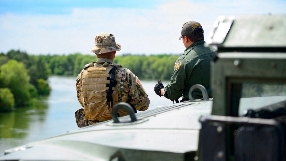 FILE: A Texas Guardsmen and a Customs and Border Patrol agent in Texas. Border Patrol