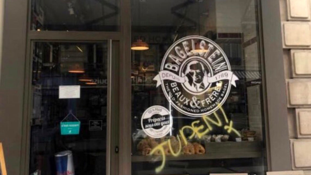 Anti-Semitic graffiti was discovered on a bagel shop in Paris on Saturday, as police forces and anti-government protesters clashed in other parts of the city.