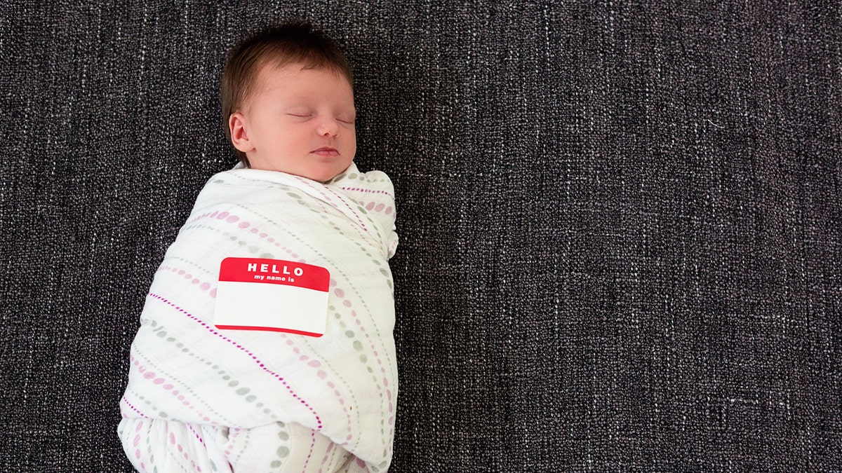 Sleeping baby with name tag