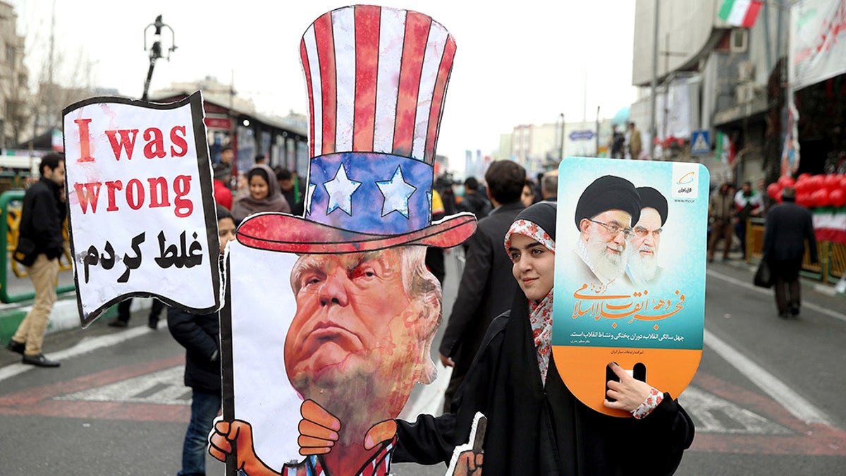 An Iranian woman holds an effigy of US president Donald Trump, during a rally marking the 40th anniversary of the 1979 Islamic Revolution, in Tehran, Iran, Monday, Feb. 11, 2019.