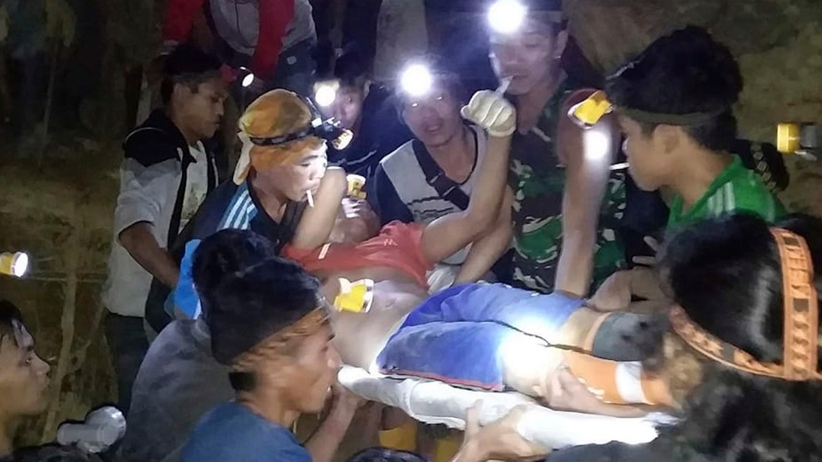 In this undated photo released by Indonesian Search And Rescue Agency (BASARNAS) rescuers evacuate a survivor from a collapsed gold mine in Bolaang Mongondow, North Sulawesi, Indonesia.