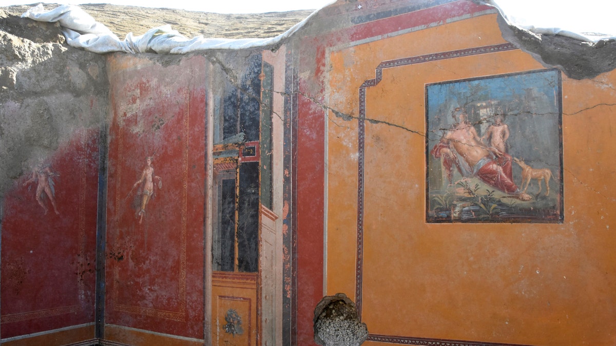 This undated photo provided Thursday, Feb. 14, 2019 by the Parco Archeologico di Pompei (Archeological Park of Pompei) shows the atrium of a house with a fresco portraying the mythological hunter Narcissus, right, in Pompeii, near Naples, Italy. Archaeologists have discovered a fresco in an ancient Pompeii residence that portrays the mythological hunter Narcissus, who fell in love with his own reflection, in a house where a fresco was found late last year depicting a sensual scene between the Roman god Jupiter disguised as a swan and Leda, a queen of Sparta from Greek mythology. (Parco Archeologico di Pompei via AP)