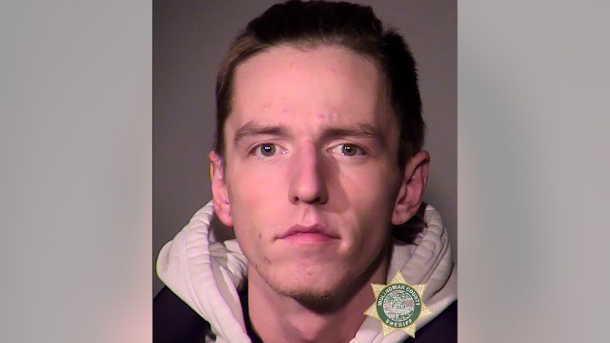 Douglas B. Smyser, 21, was arrested Wednesday in Portland after his disturbing behavior forced a LA-bound plane to divert, a complaint said.