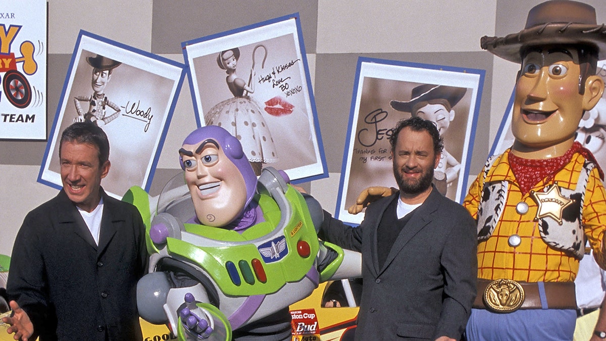 Actor Tim Allen, Buzz Lightyear, actor Tom Hanks and Woody attend the 