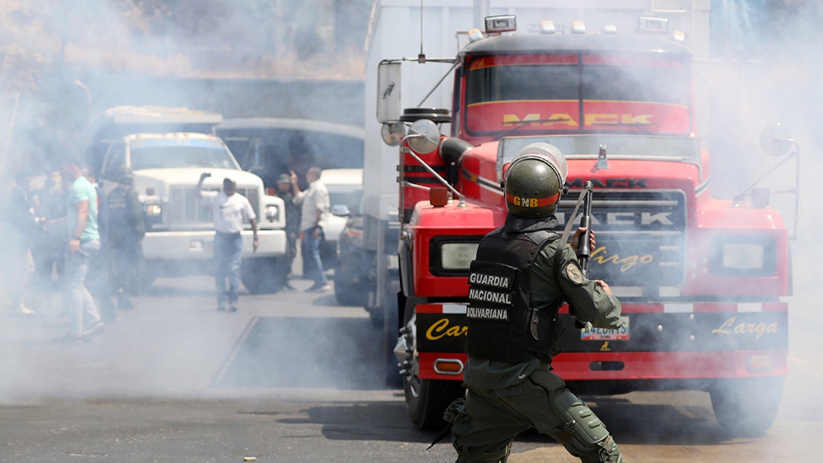 Lawmaker members of the Venezuelan National Assembly and supporters of Juan Guaido, who many nations have recognized as the country's rightful interim ruler, clash with security forces as they block the road on the outskirts of Mariara, Venezuela February 21.