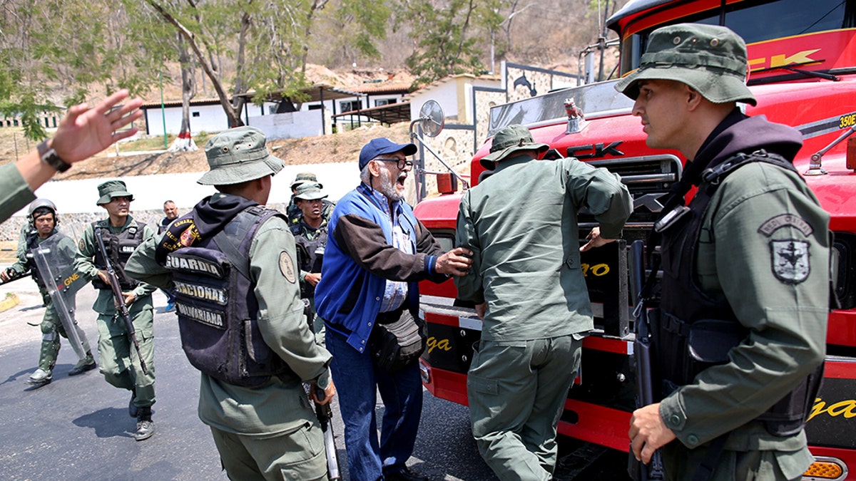 Lawmaker members of the Venezuelan National Assembly and supporters of the Venezuelan opposition leader Juan Guaido, who many nations have recognized as the country's rightful interim ruler, clash with security forces as they block the road on the outskirts of Mariara, Venezuela February 21, 2019. REUTERS/Andres Martinez Casares - RC18C9C08980