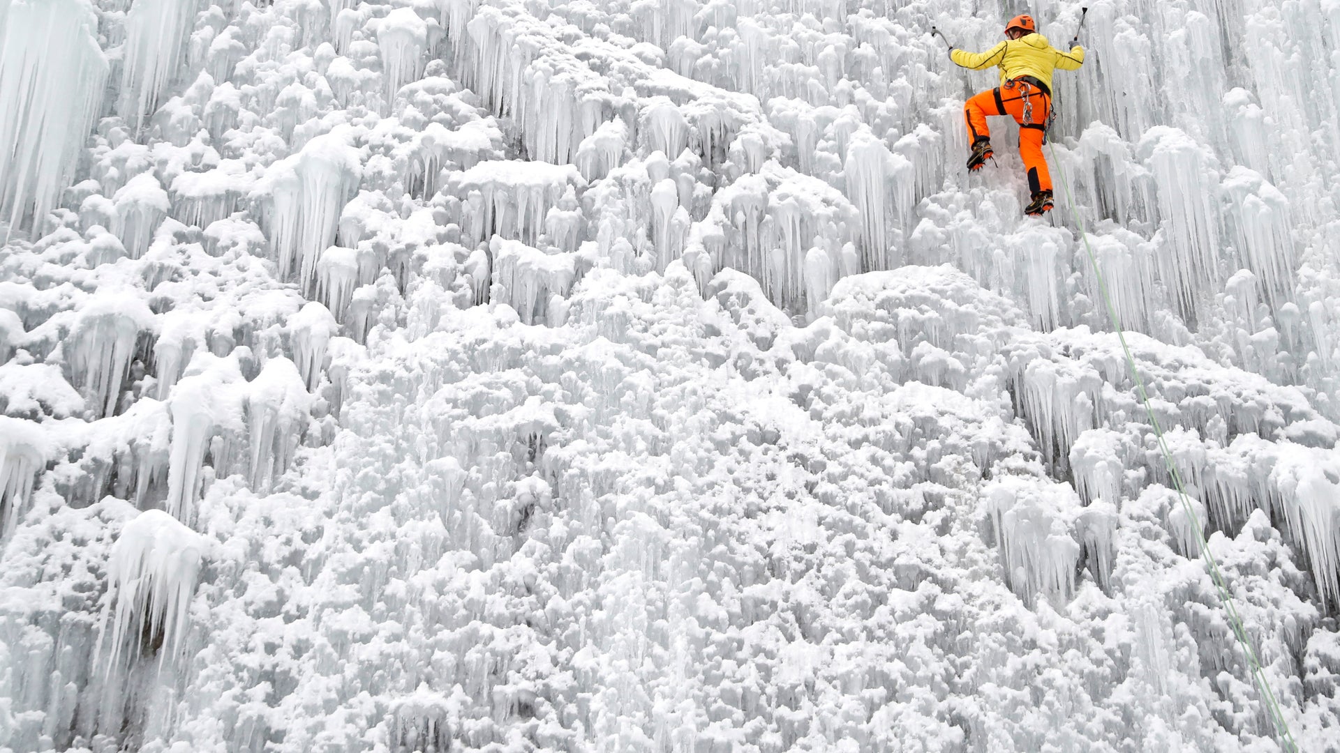 A man climbs up an artificial ice wall located in a courtyard in the city of Liberec, Czech Republic, January 27, 2019. 