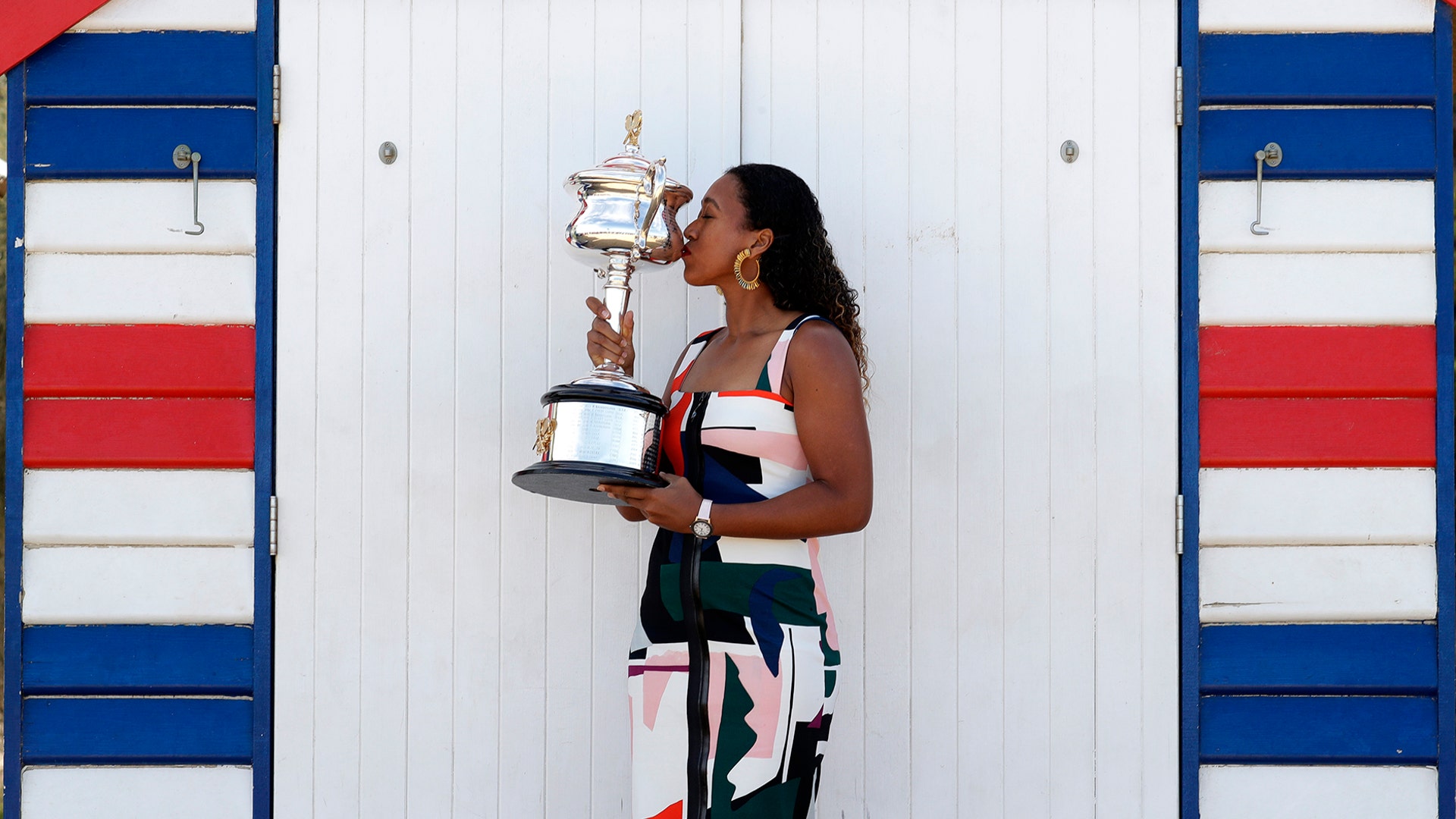 Japan's Naomi Osaka kisses her trophy the Daphne Akhurst Memorial Cup at Melbourne's Brighton Beach following her win over Petra Kvitova of the Czech Republic in the women's singles final at the Australian Open tennis championships in Melbourne, Australia, January 27, 2019. 
