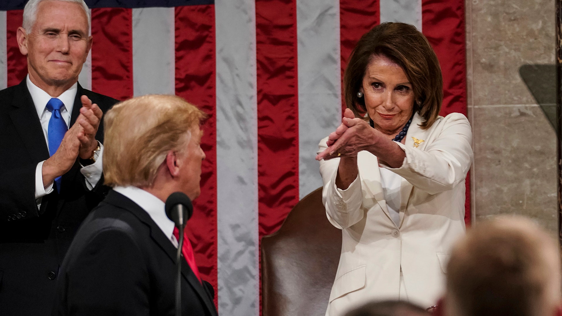 President Donald Trump turns to House Speaker Nancy Pelosi and Vice President Mike Pence as he delivers his State of the Union address in Washington, Feb. 5, 2019. 