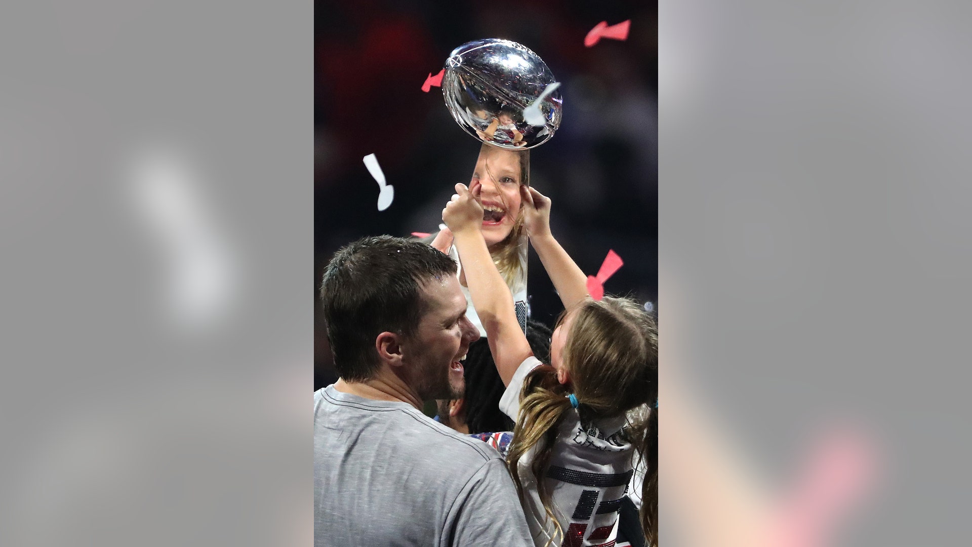 Tom Brady of the New England Patriots celebrates with daughter Vivian Lake Brady while they hold the Vince Lombardi trophy after the Patriots won Super Bowl LIII in Atlanta, Feb. 3, 2019.