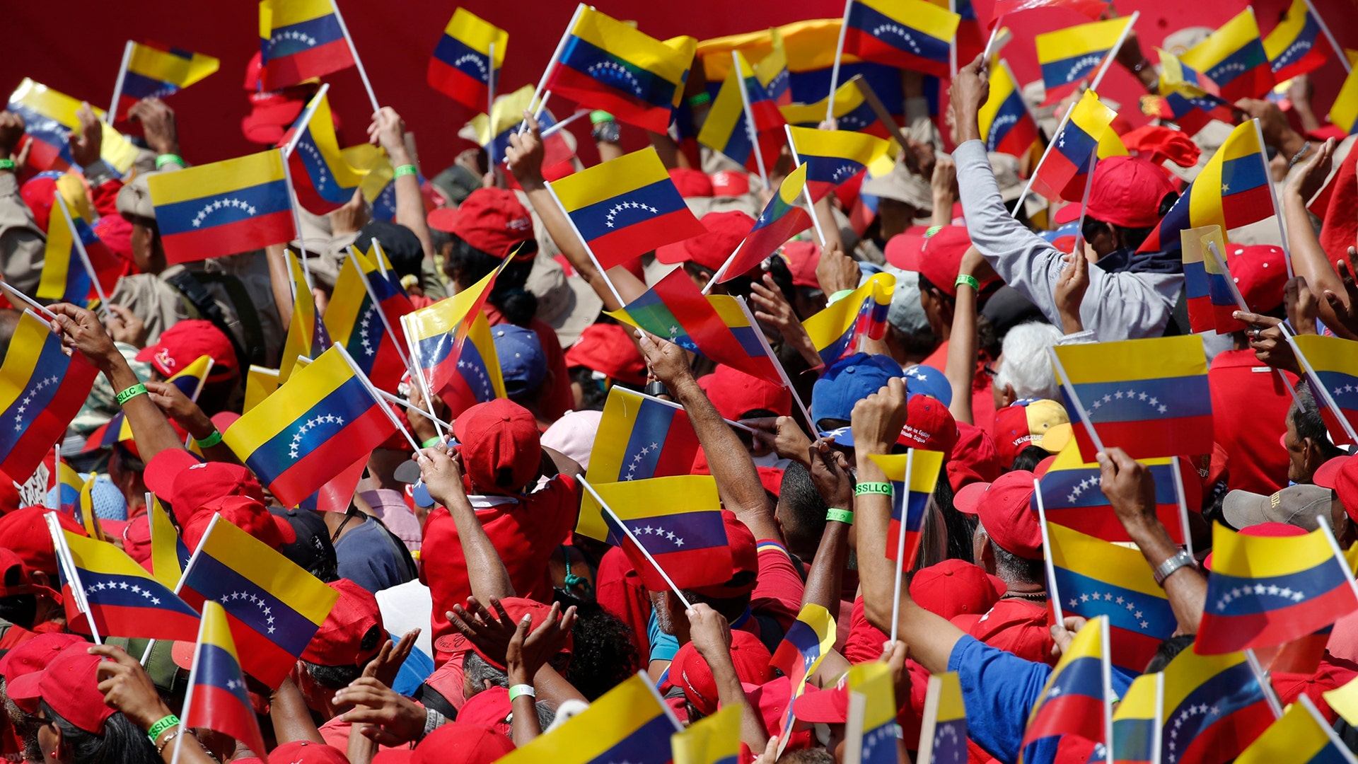 Supporters of President Nicolas Maduro wave Venezuelan national flags during a rally in Caracas, Venezuela, Feb. 2, 2019. 