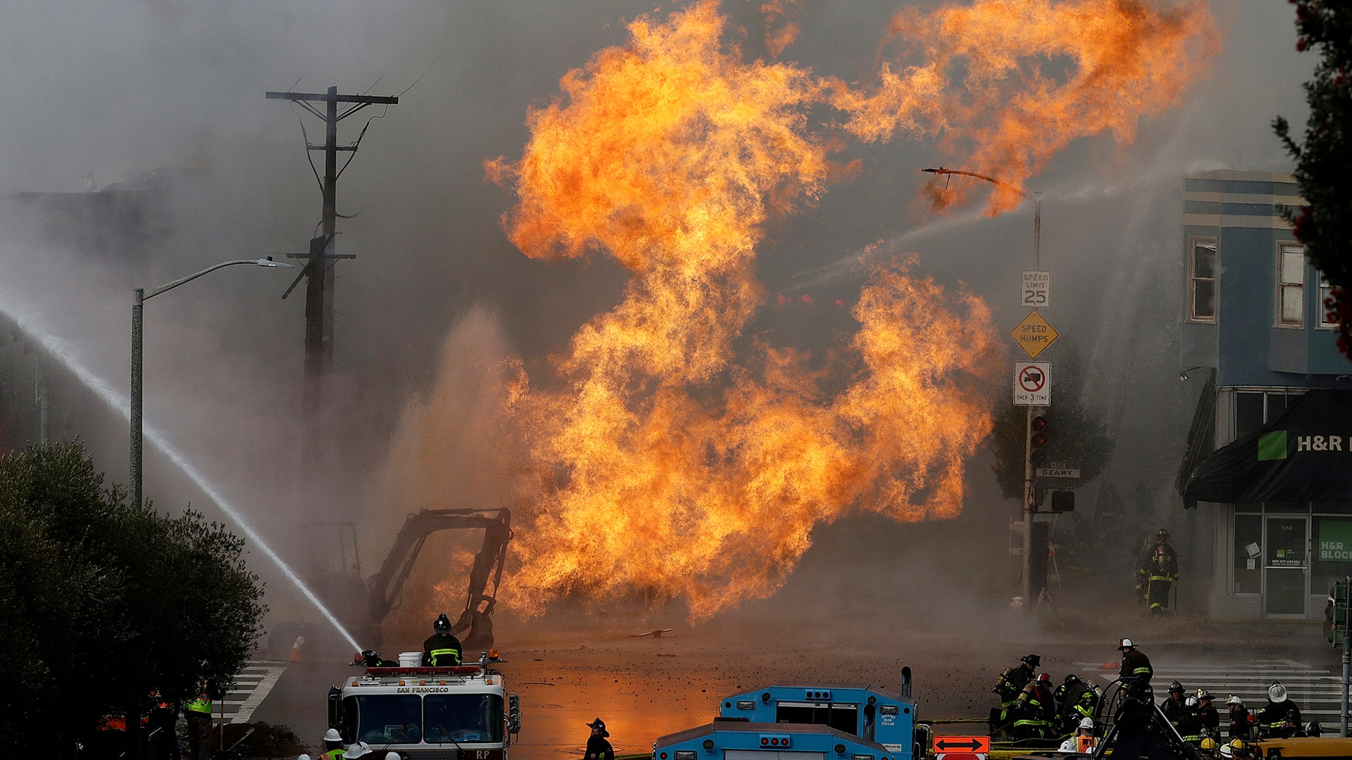 San Francisco firefighters battle a fire from a gas explosion on Geary Boulevard in San Francisco, Feb. 6, 2019. 