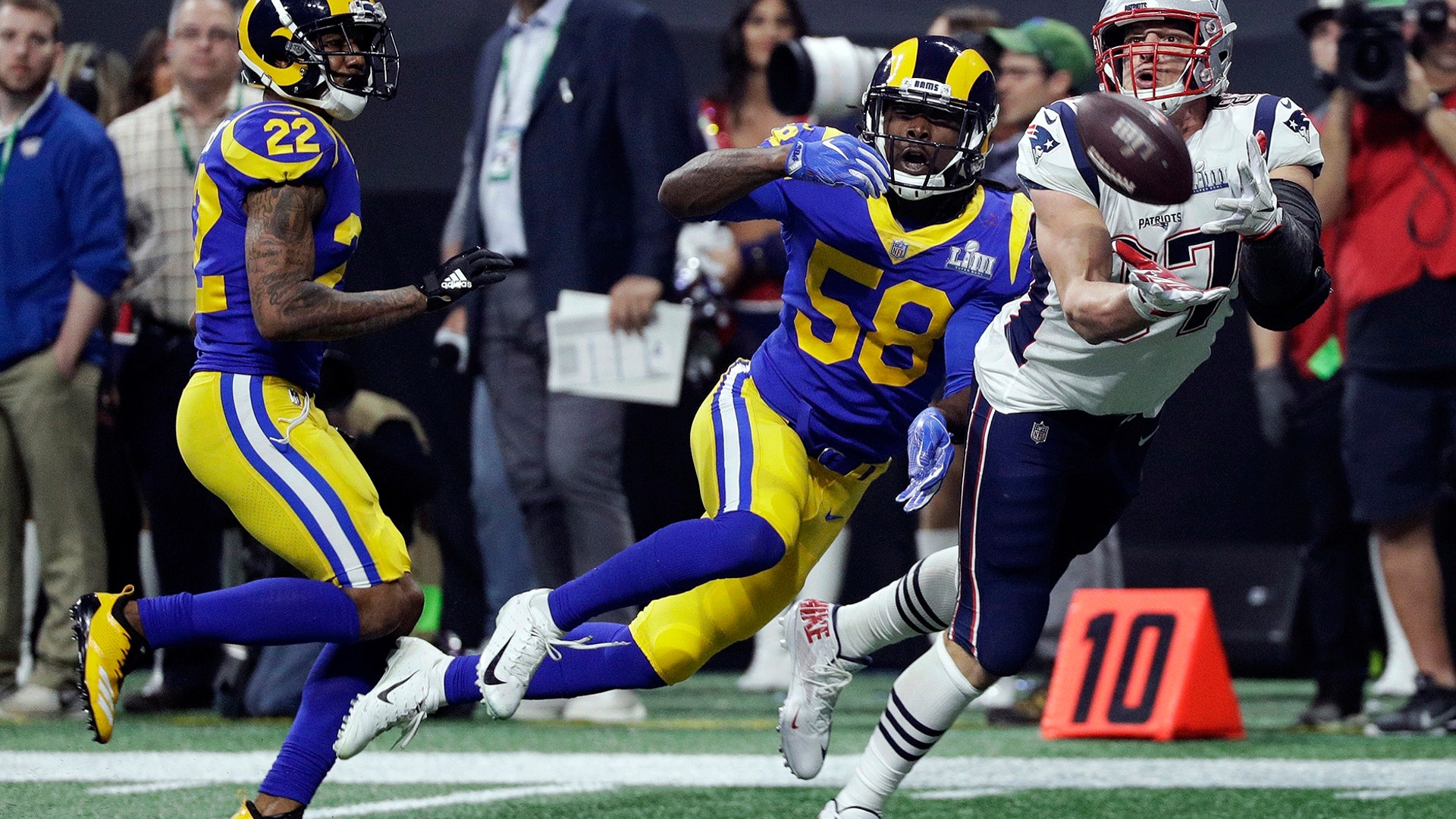 New England Patriots' Rob Gronkowski catches a pass in front of Los Angeles Rams' Marcus Peters and Cory Littleton during the fourth quarter of Super Bowl LIII in Atlanta, Feb. 3, 2019.