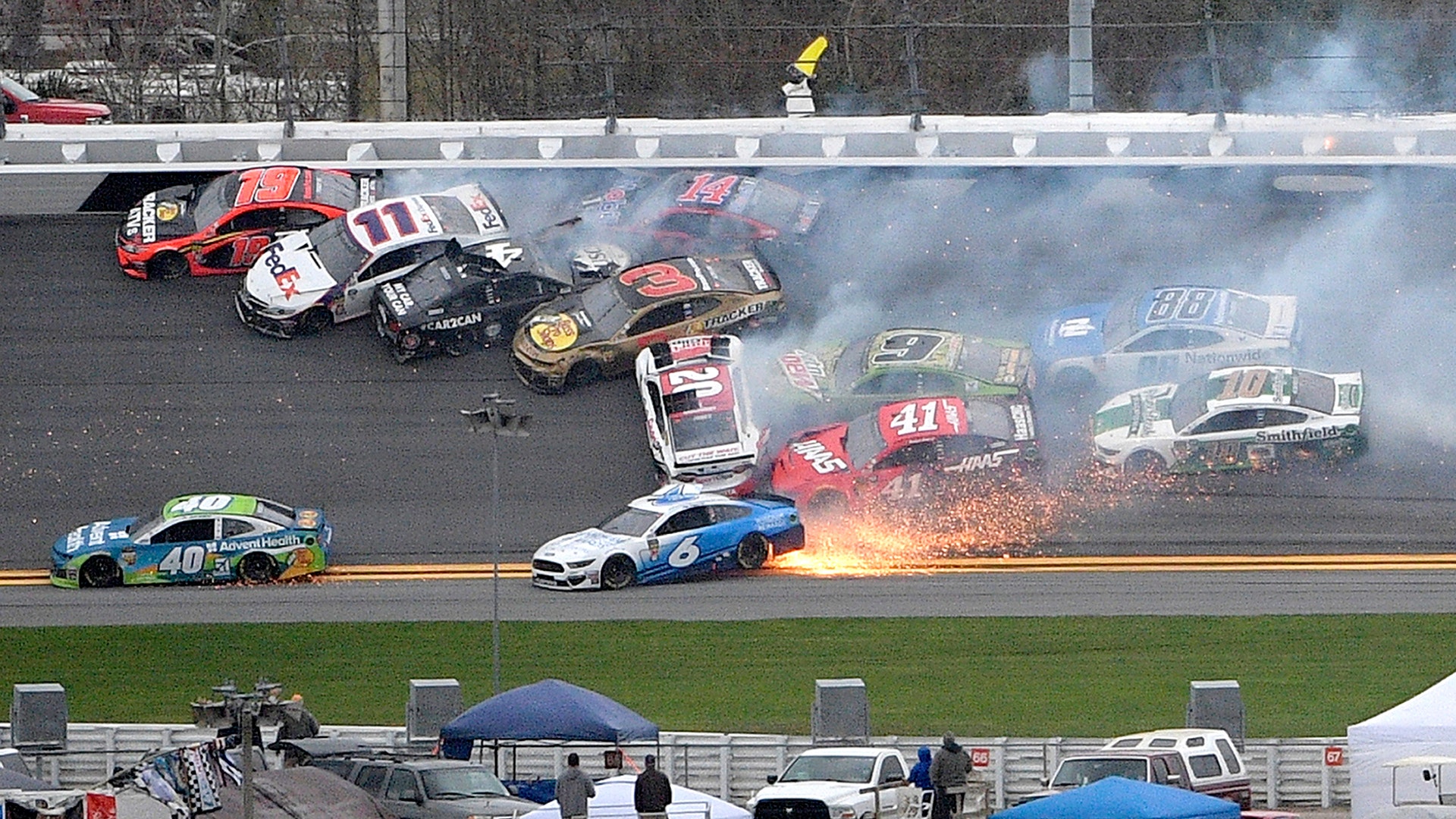 Drivers Martin Truex Jr., Denny Hamlin, Kevin Harvick, Austin Dillon, Clint Bowyer, Erik Jones, Chase Elliott, Daniel Suarez, Ryan Newman, Alex Bowman and Aric Almirola are involved in a multi-car pileup during the NASCAR Clash auto race at Daytona International Speedway, in Daytona Beach, Feb. 10, 2019.