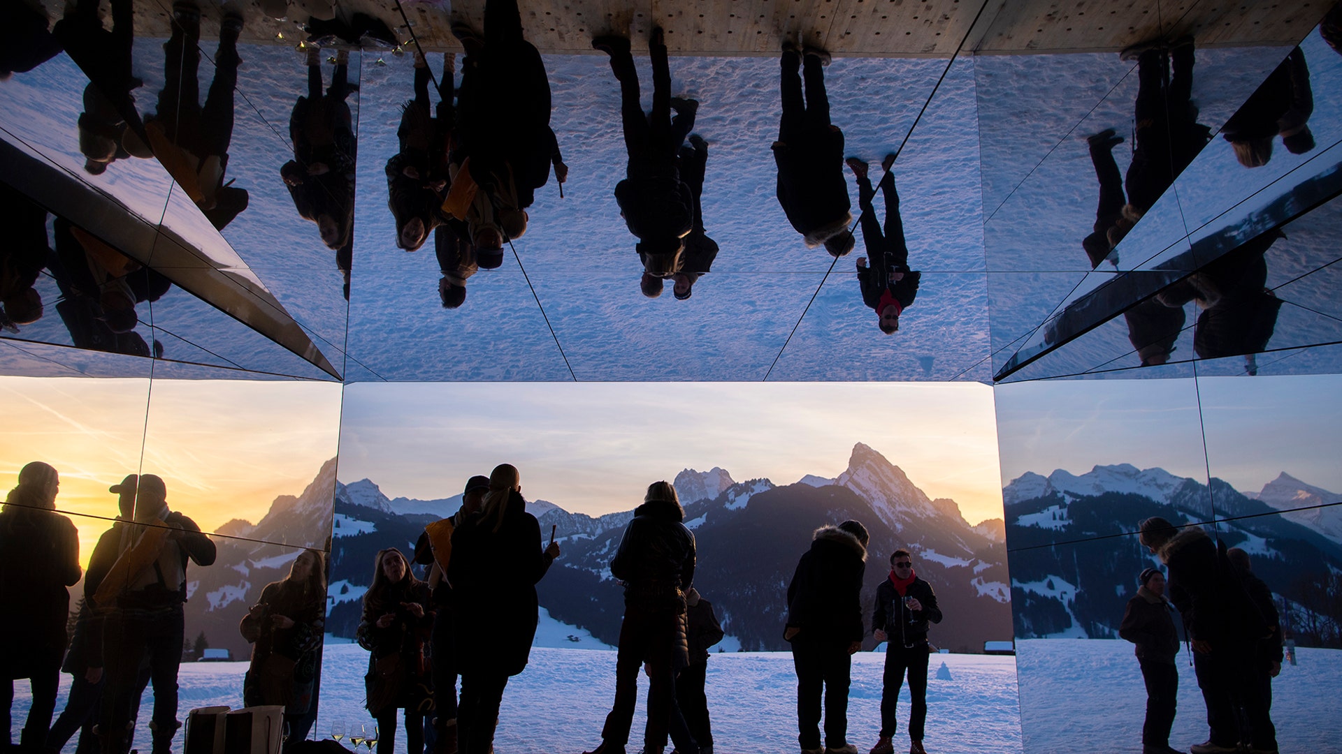 People visit the installation called 'Mirage Gstaad' by American artist Doug Aitken, in Gstaad, Switzerland, Feb. 20, 2019.