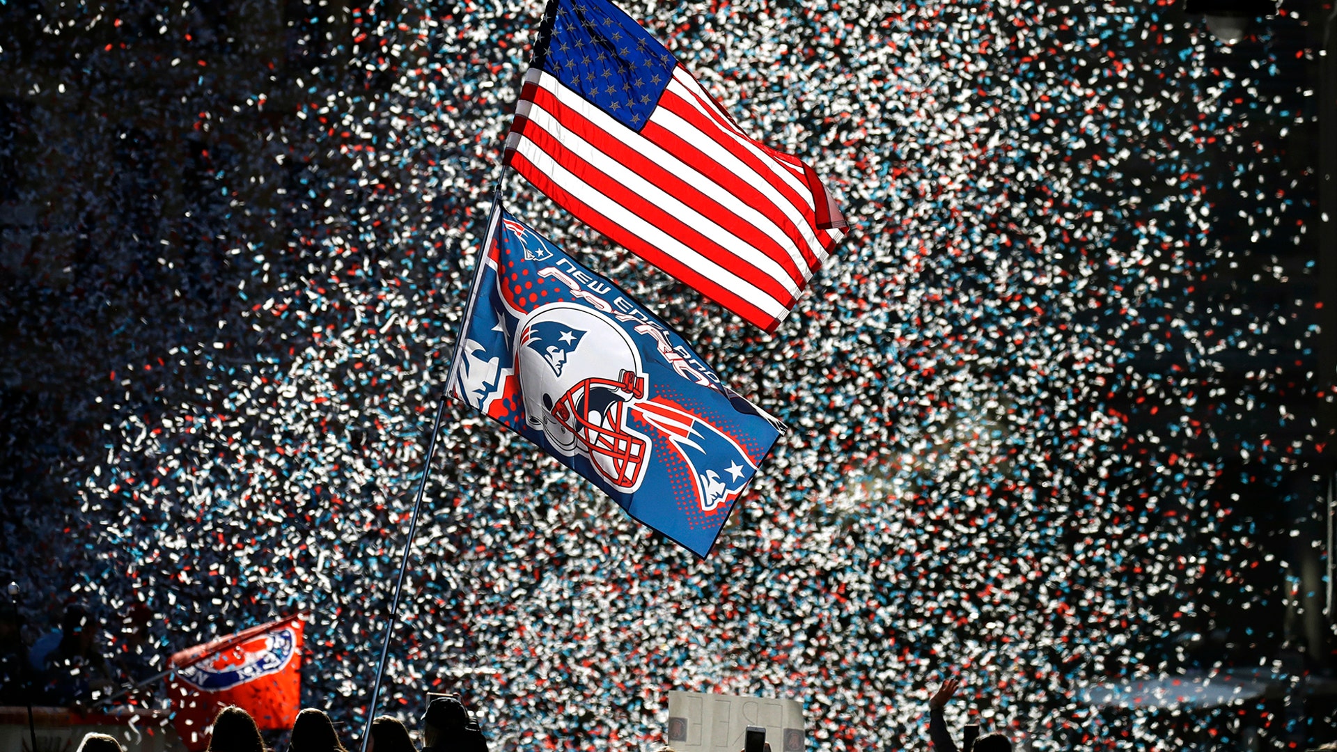 Confetti flies as fans watch the New England Patriots Super Bowl parade in Boston, Feb. 5, 2019.