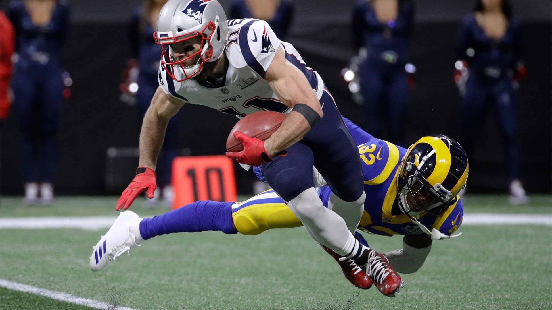 New England Patriots Julian Edelman breaks away from Los Angeles Rams' Troy Hill during the Super Bowl in Atlanta, February 3. 2019