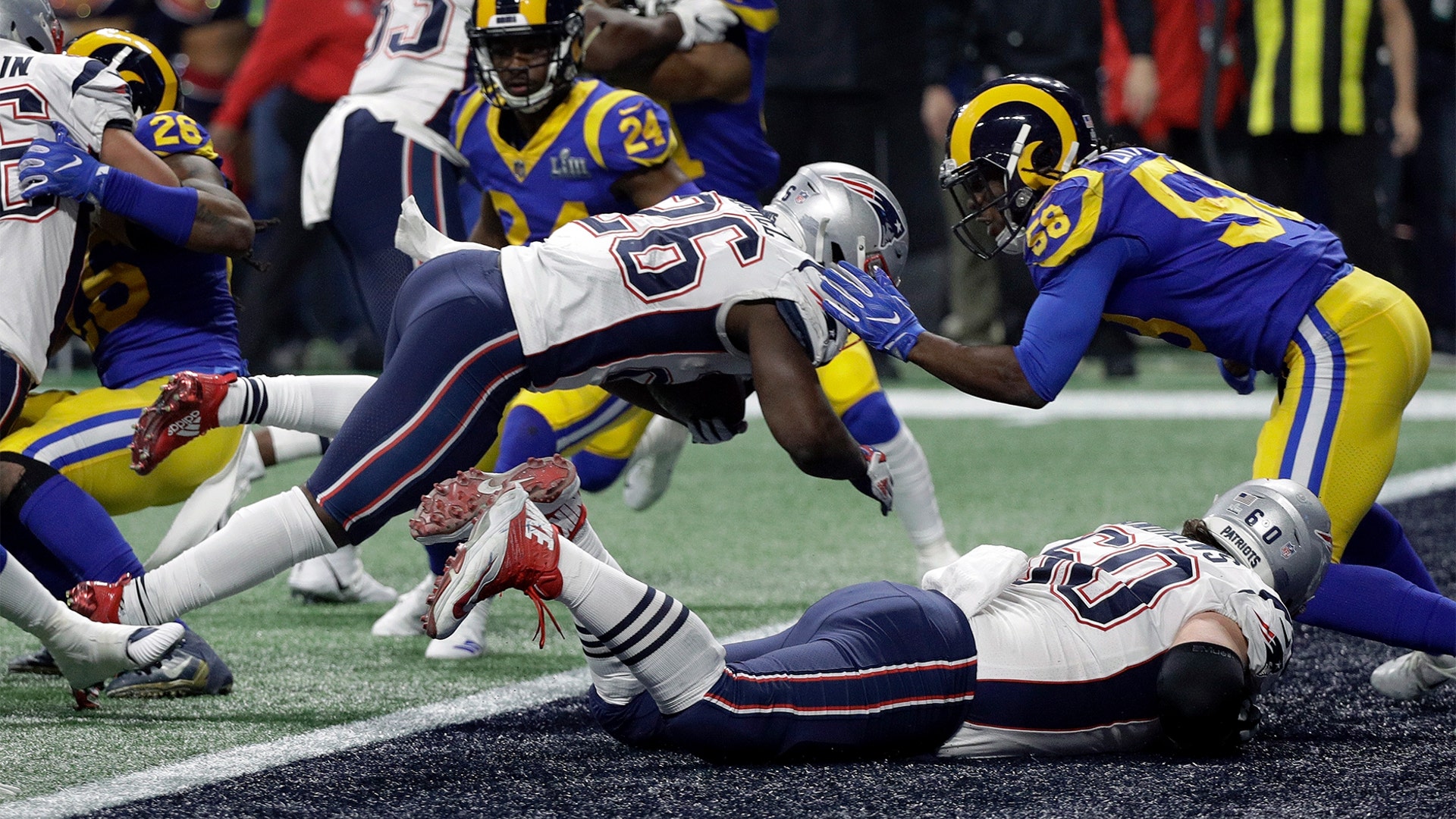 New England Patriots Sony Michel dives over the goal line for a touchdown in front of Los Angeles Rams' Cory Littleton during the second half of the Super Bowl in Atlanta, February 3. 2019.