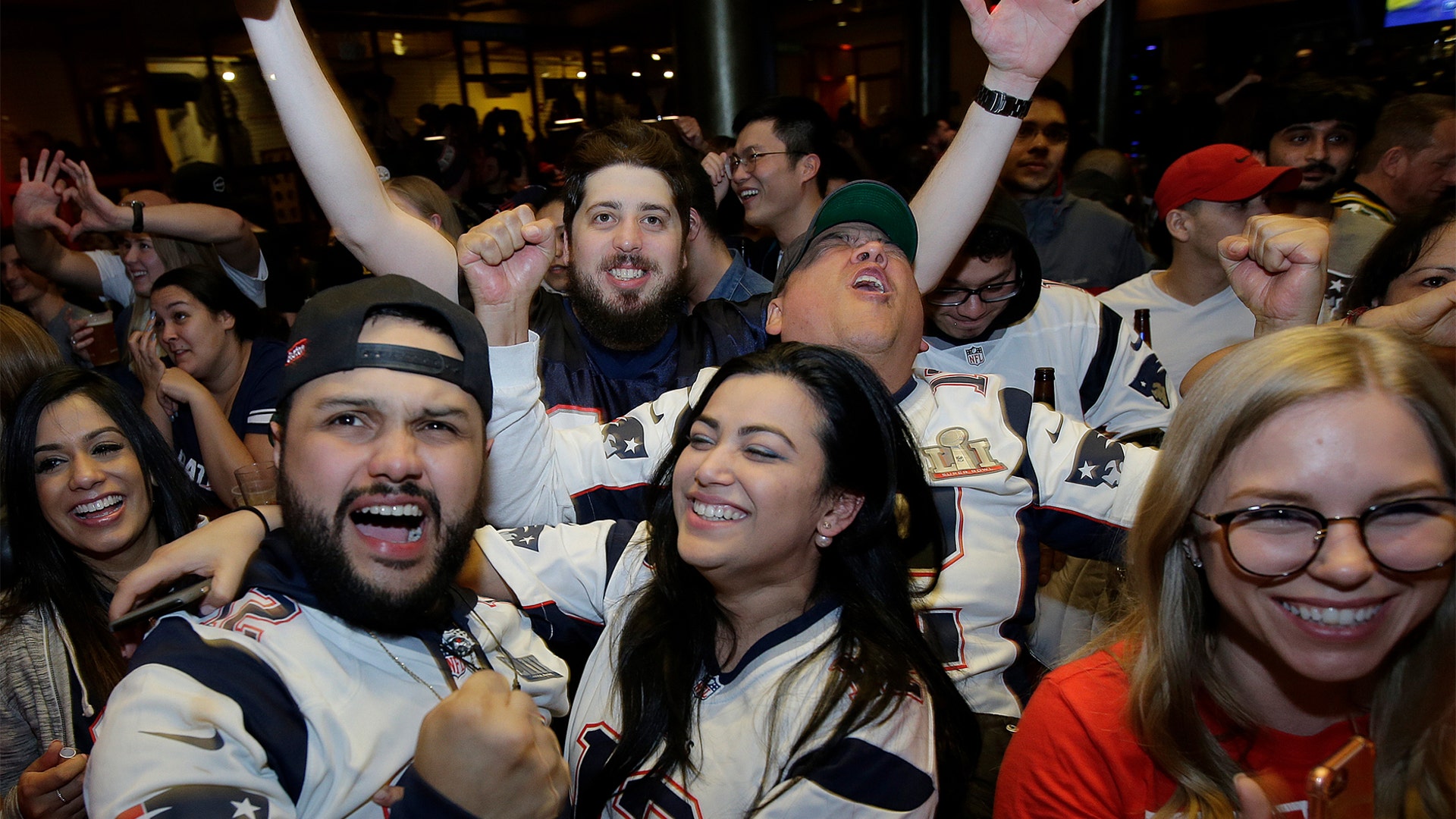 New England Patriots fans cheer while watching the Super Bowl in a bar in Boston, February 3, 2019.
