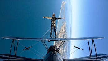 United flight attendant walks onto biplane wing mid-air in birthday stunt