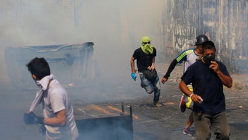 Venezuelan troops abandon posts amid violent clashes with protesters at Colombian border