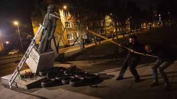 Man charged for toppling statue of Polish priest over abuse
