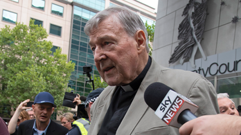 The Latest: Victim's father to sue church over Pell abuse