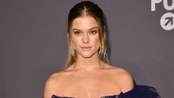 Nina Agdal shows off impressively toned legs, arms in purple bikini during beach run