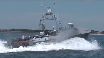 Navy arms unmanned attack drone boats with weapons, guns and missiles