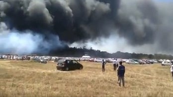 Parking lot blaze burns over 200 cars